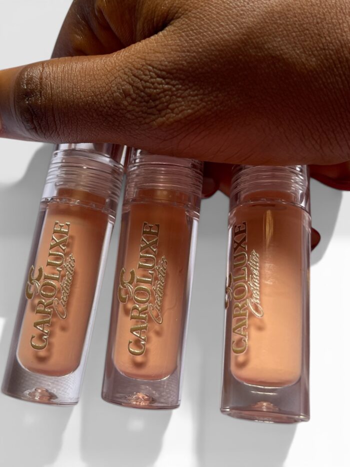 Caroluxe Ivory Nude Gloss is a soft, elegant nude shade designed to give your lips a smooth, creamy glow with a luxurious glossy finish. Its lightweight, non-sticky formula melts effortlessly onto the lips, delivering comfortable wear and a naturally polished look. The perfect everyday nude, Ivory Nude complements every skin tone and pairs beautifully with both minimal and full glam makeup looks. Wear it alone for a soft classy vibe or layer it with your favorite lip combo for extra shine and dimension. Hydrating, glossy, and effortlessly chic — Caroluxe Ivory Nude Gloss is the definition of timeless beauty.